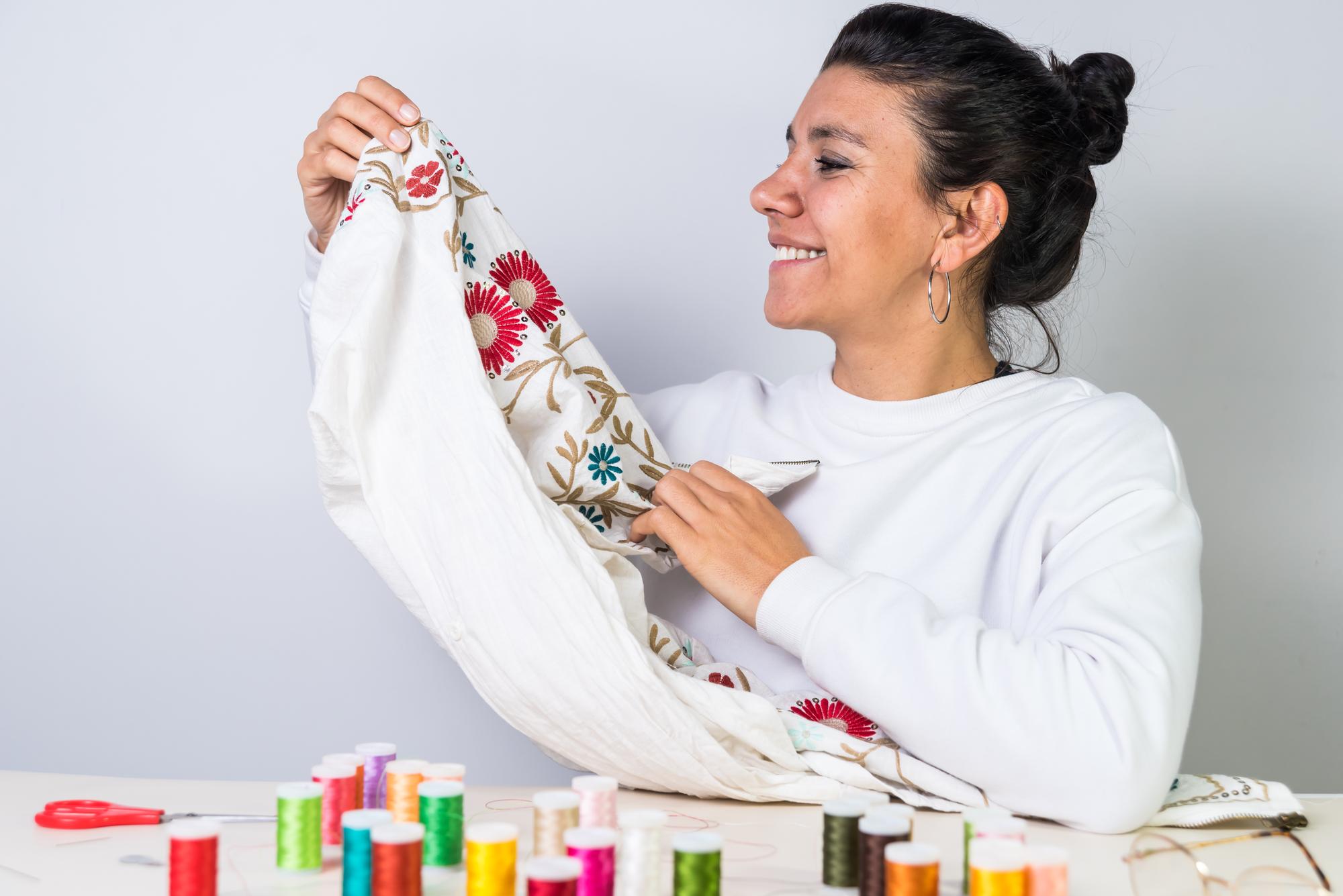 Instructor demonstrating hand embroidery stitches on linen